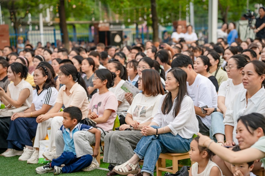 A large crowd of people watching an outdoor event.